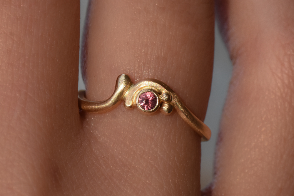 A closeup photo of drop earrings made with topaz stones