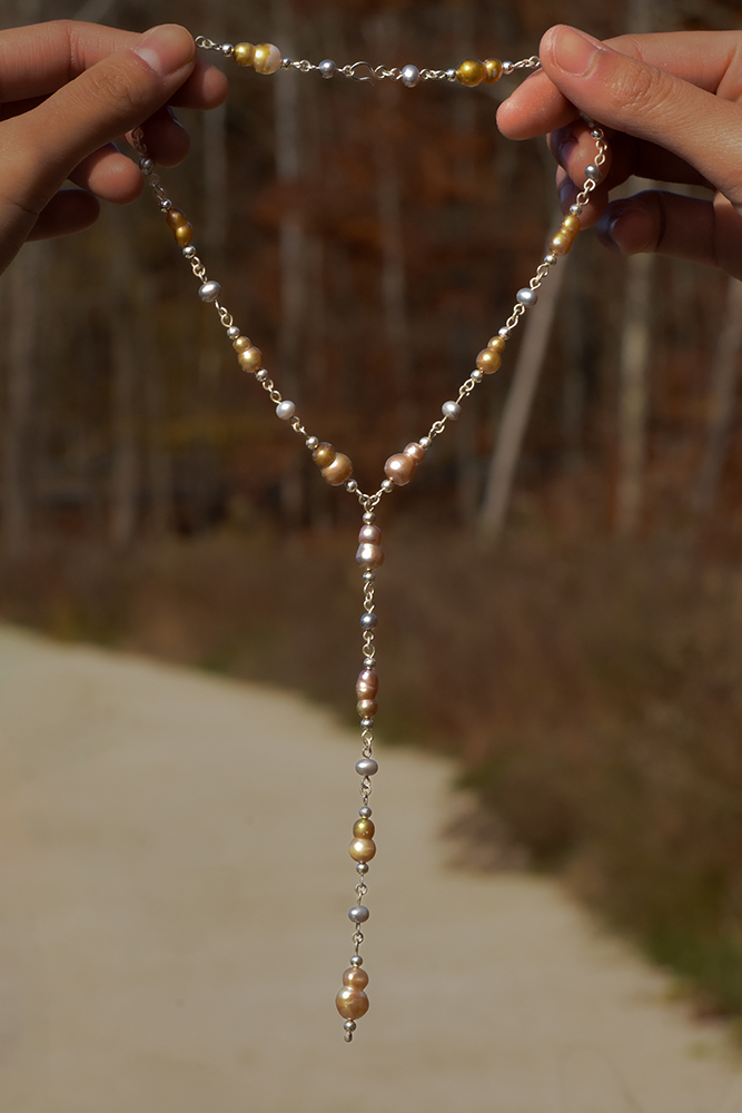A photo of a necklace made from sterling silver and freshwater pearls
