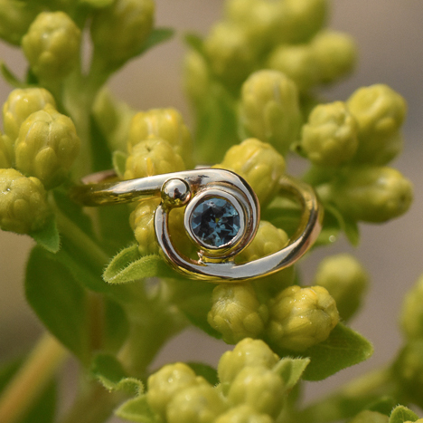 A photo of a 14k gold ring with a Montana blue sapphire